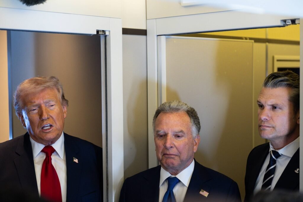 President Donald Trump speaks to reporters aboard Air Force One, March 7, 2026, as Steve Witkoff, center, Trump’s special envoy to the Middle East, and Defense Secretary Pete Hegseth, right, look on. (Tierney L. Cross/The New York Times)